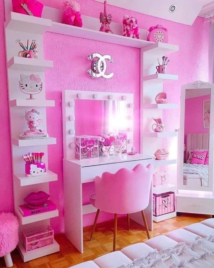 a pink bedroom with hello kitty decorations and accessories on the wall, along with white shelving