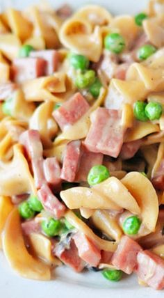 pasta with ham and peas on a white plate