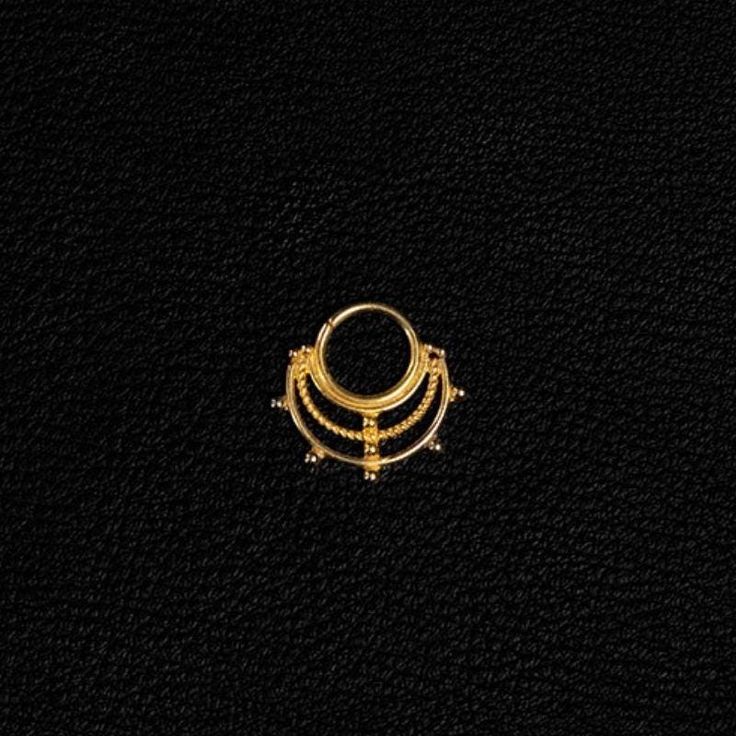 an image of a gold ring on a black background