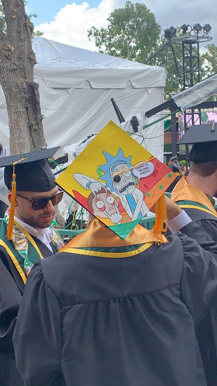 a group of people standing around each other in graduation gowns and cap's