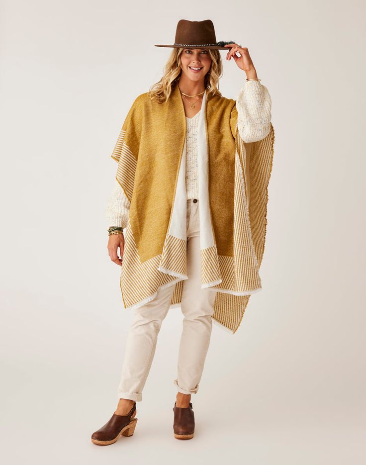 The Poncho that completes, and better yet, matches, every outfit in your closet. Reverse from a light khaki to a warm wood color. This poncho is what it means to be stylish yet effortless. Beach Cape Shawl For Fall, Beige Poncho For Layering, One Size Beige Poncho For Layering, Brown Poncho For Layering, One Size, One Size Brown Beach Outerwear, Beige Poncho For Spring Layering, One Size Brown Outerwear For Beach, Fall Beach Cape Shawl, Fall Beach Cape