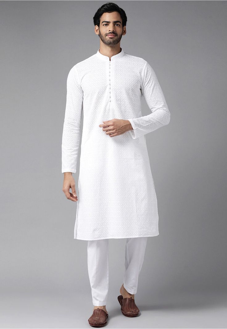 Pure Cotton Kurta in White This Readymade attire is Enhanced with Moulded Buttons, Pockets, Chikankari and Resham Work. Crafted in Chinese Collar Neck and Full Sleeve Available with a Poly Cotton Pajama in Off White Do note: Footwear shown in the image is for presentation purposes only. Half to one inch may vary in measurement. (Slight variation in actual color vs. image is possible) Cheap White Cotton Kurta, Transitional White Churidar With Cutdana, White Cotton Sherwani With Cutdana, White Dabka Churidar For Puja, White Self-design Sherwani For Puja, White Sherwani With Self Design For Puja, White Long Sleeve Churidar For Puja, White Cotton Kurta With Zari Work, White Dabka Set For Puja