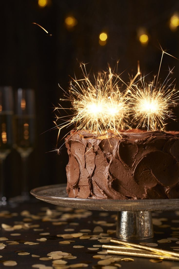 a chocolate cake with sparklers on top