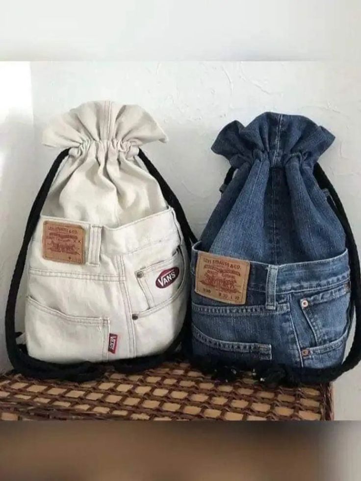 two denim bags sitting on top of a table