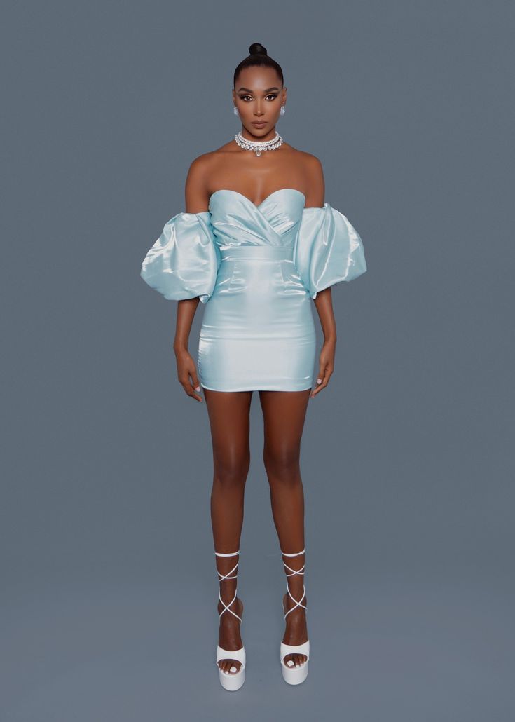 Blue Satin Puff Sleeves Mini Dress A modern take on Old Hollywood glamour featuring an off-shoulder semi-sweetheart neckline and voluminous puffy sleeves. It’s a fitted dress with a tailored construction, that exudes elegance. Stretch Level one – no stretch (level one – three) Wearing Model is 5'9" wearing size XS (usual dress size 2) Composition Polyester 100% Garment Care Dry Clean Only Buy Blue Satin Puff Sleeves Mini Dress online at Guilty Of Glam. Poofy Sleeves, Big Dresses, High Fashion Outfits, Mini Dresses Online, Old Hollywood Glamour, Puffy Sleeves, Slim Dresses, Blue Satin, Hollywood Glamour