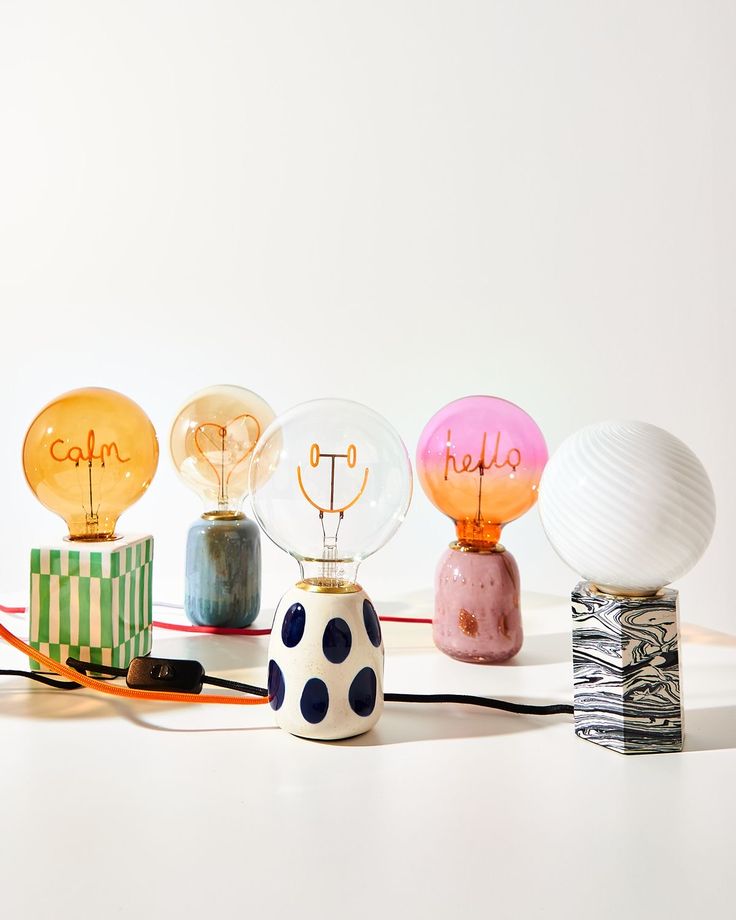 five different colored lamps sitting next to each other