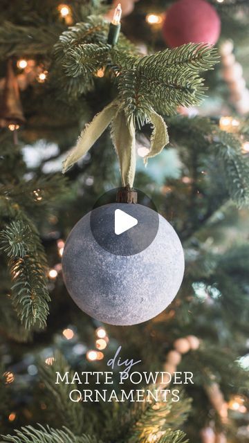 an ornament hanging from the top of a christmas tree with text overlay that reads diy matte powder ornaments