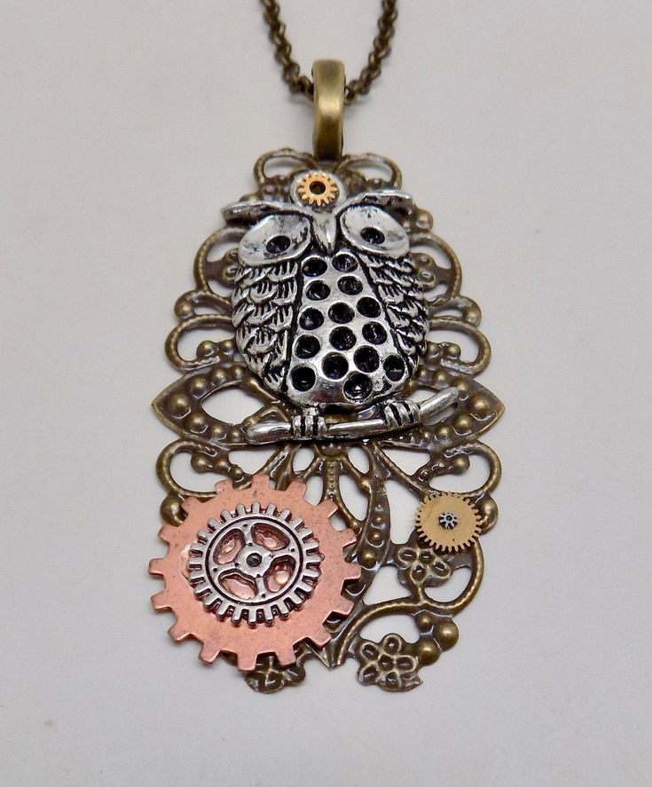 "Awesome steampunk pendant of owl charm and gears mounted on brass victorian filigree. The size is 2\" by 1 1/4\" and it has 24\" antique brass chain." Handmade Steampunk Brass Necklaces, Handmade Steampunk Brass Necklace, Steampunk Metal Jewelry With Antique Finish, Steampunk Jewelry With Vintage Charm, Steampunk Jewelry With Antique Metal Finish, Steampunk Bronze Pendant Necklace, Steampunk Antique Gold Metal Jewelry, Steampunk Bronze Brass Jewelry, Steampunk Brass Jewelry In Bronze