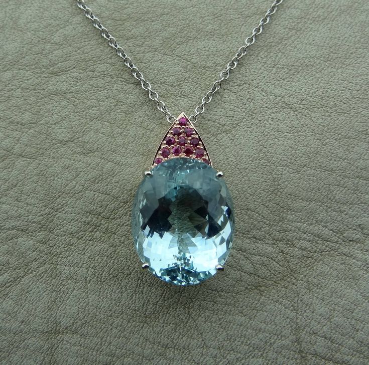 "This handmade one of a kind pendant is made in 14k rose and white gold with a huge fine color natural Aquamarine. The 12 pave set rubies are of fine quality and .36 cts total weight. The 14k white gold chain is included and can be made 16,17 or 18 inch long. We love this pendant because it represents the way jewelry should be made with craftsmanship and quality. This pendant is anything but ordinary. Our pieces are designed and made with craftsmanship and sustainability in mind, our designs are Luxury Oval Cabochon Gemstones, Luxury Teardrop Gemstones, Oval Multi-stone Gemstones For Formal Occasions, Oval Luxury Gemstones With Accents, Luxury Oval Gemstones, Luxury Oval Gemstones With Accents, Luxury Oval Sapphire Gemstones, Fine Jewelry Briolette Gemstones For Formal Occasions, Luxury Oval Jewelry With Accent Stones