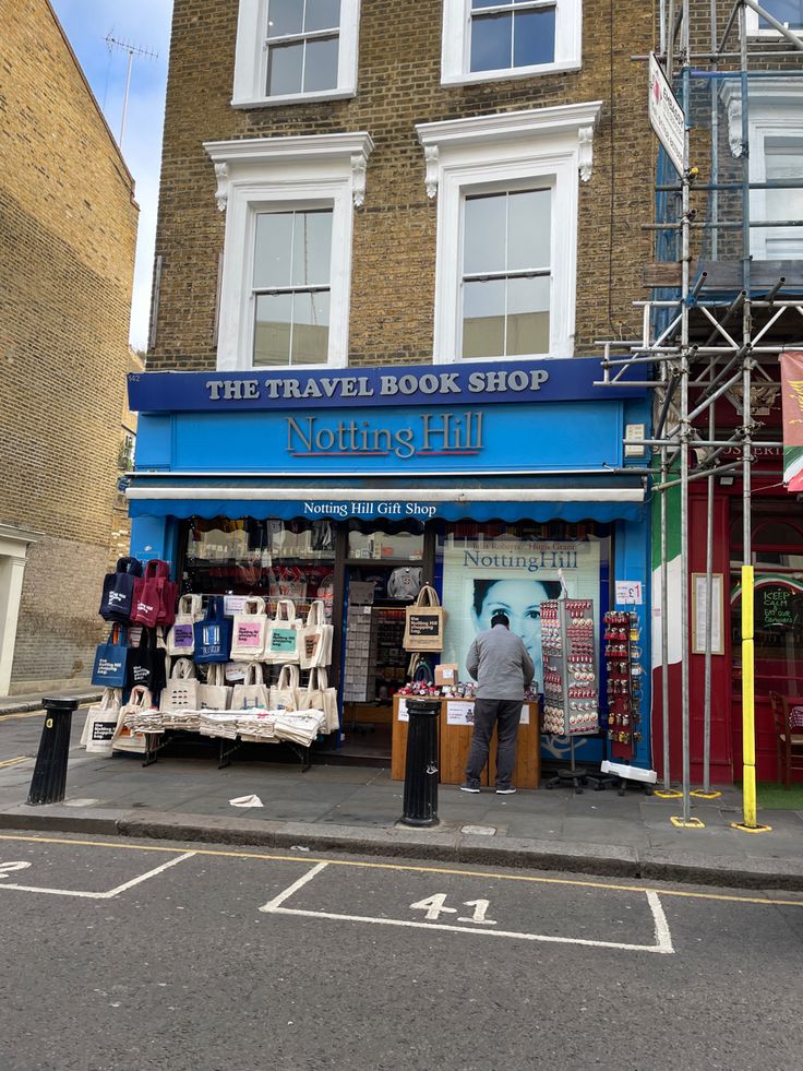 the travel book shop is on the side of the road in front of a building