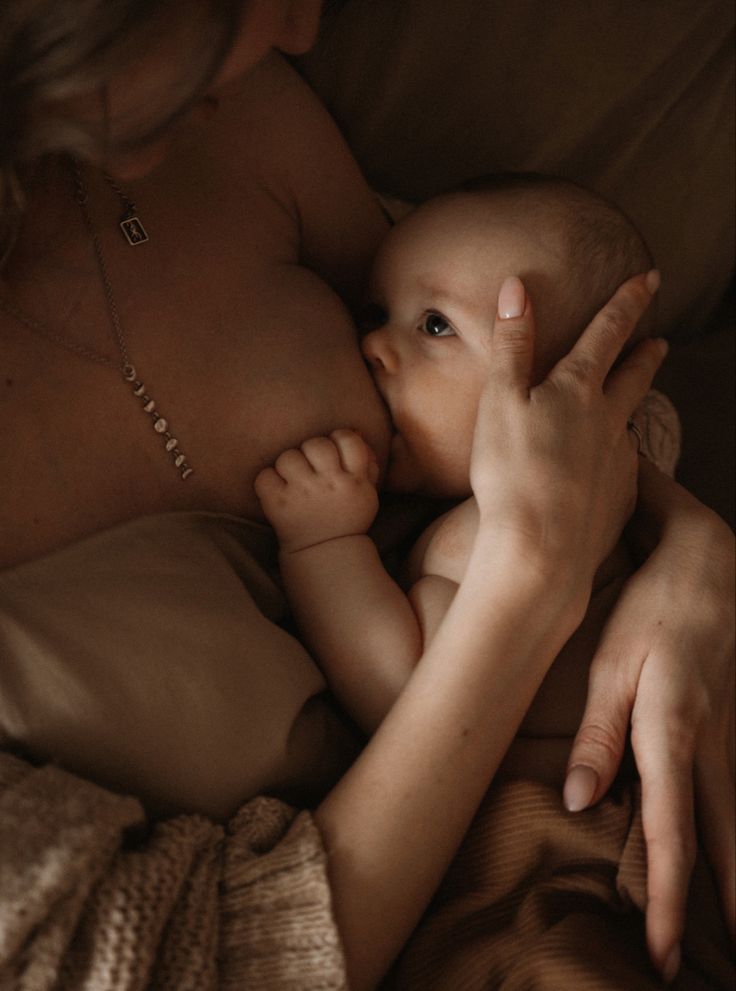 a woman holding a baby in her arms