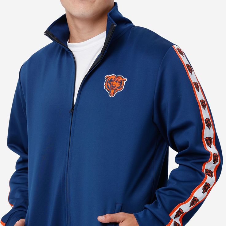 A jacket that you'll be jacked up to wear. Bundle up for your jog around the block with this Chicago Bears Stripe Logo Track Jacket. Features All-over team-colored design so you can rep the team in style Embroidered team logo display on left chest, in case there were any doubts where your allegiances lie Stripe accents on sleeves with repeat team logo displays for a little extra team spirit Zip-up structure so you can zip up and party down Long sleeves so you can stay warm, even on the chillier Vintage Tommy Hilfiger Jackets, Quilted Sweater, Varsity Letterman Jackets, Logo Display, Color Block Jacket, Tommy Hilfiger Jackets, Vintage Polo Ralph Lauren, Satin Jackets, Leather Motorcycle Jacket