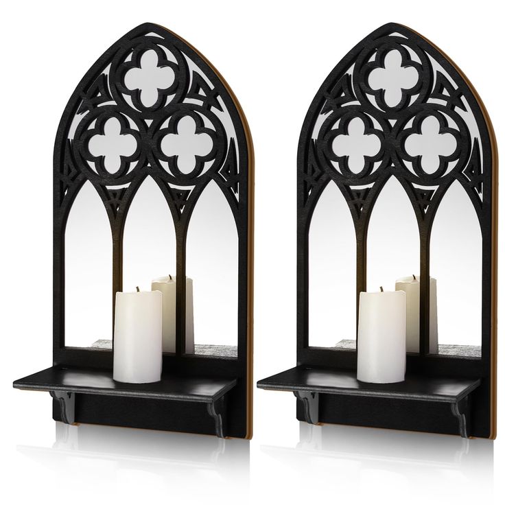 two candle holders with candles on them and one is shaped like an arched window,