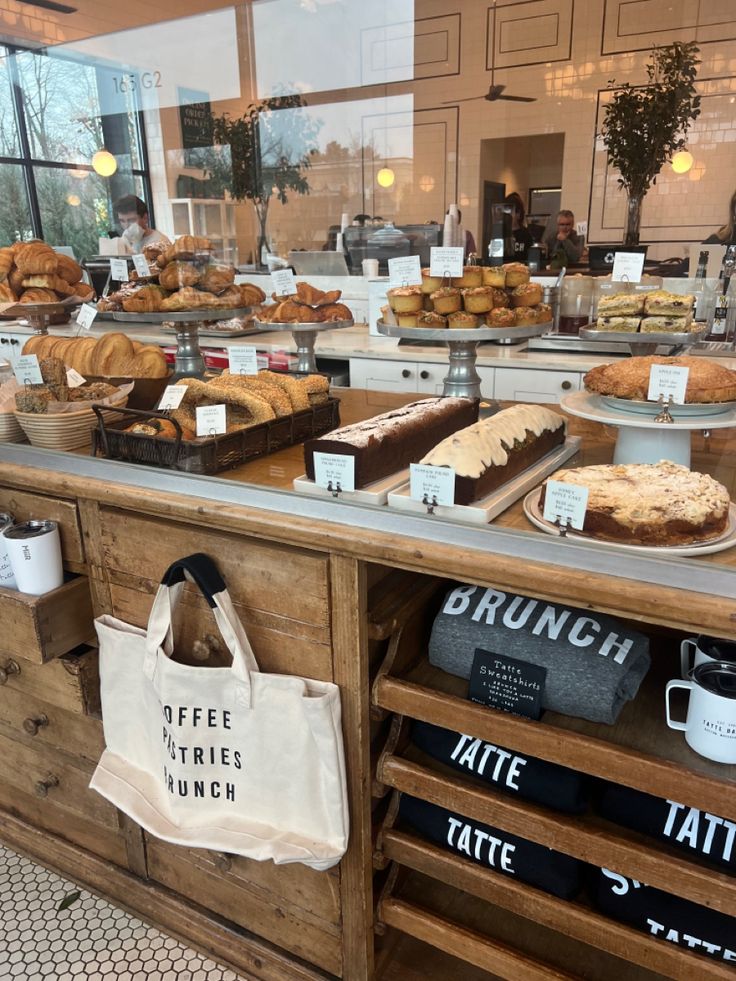 a bakery counter filled with lots of pastries and coffee bags on it's sides