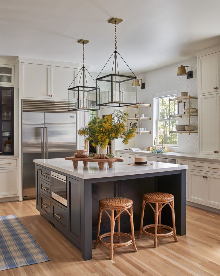 a kitchen island with two stools next to it