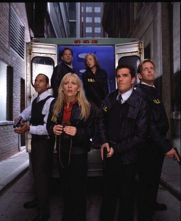 a group of people standing in front of an ambulance