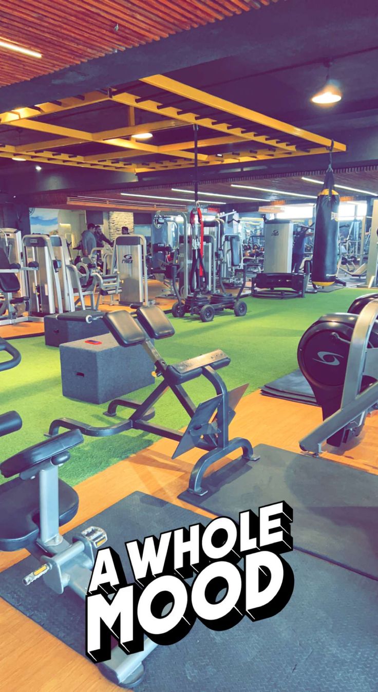 a gym filled with different types of exercise equipment and workout mats that read'a whole mood '