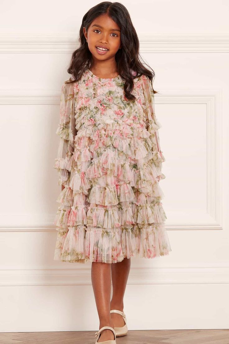 Description & Details NEW SEASON. The English Rose Ruffle KIDS Dress in Sky Pink. This dress features a traditional rose print, inspired by a 1900's hand-painted artwork. Designed with delicate frills and developed in soft pink hues for a pretty, feminine look. Make the English Rose a new wardrobe favourite. - Floral printed tulle decorated with layers of tulle ruffles - Bodice and skirt are fully lined, sleeves are unlined - 100% Recycled nylon - 100% Recycled polyester lining - Multi-layered, Traditional Rose, Tulle Ruffles, Full Tulle Skirt, Traditional Roses, Sky Pink, Painted Artwork, Rose A, English Rose, Needle Thread