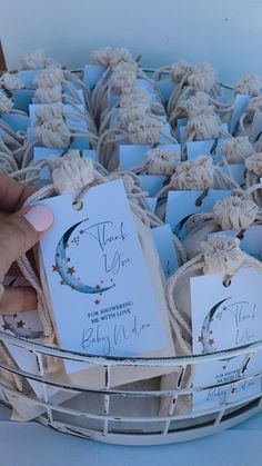 a basket filled with lots of small cards and paper tags on top of each other