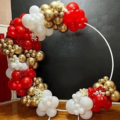 a bunch of balloons that are on the ground in front of a blackboard with gold and red decorations