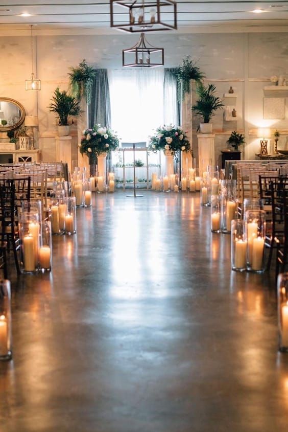 a room filled with lots of candles and chairs