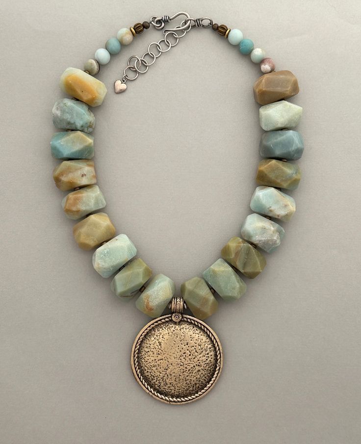 One-of-a-kind handcrafted statement necklace. Beads: amazonite, brass, sterling silver, with mixed-metal Tibetan pendant Dimensions: approximately 15.5" with 2.5" pendant + 2" extender Make a statement with this distinctive necklace! ﻿Free Shipping ﻿Refund Policy Oversized Necklace, Mixed Beads Necklace, Turquoise Statement Necklace, Pearl Statement Necklace, Beaded Jewelry Necklaces, Coin Pearls, Chunky Necklace, Classic Jewelry, Bracelets Handmade Beaded