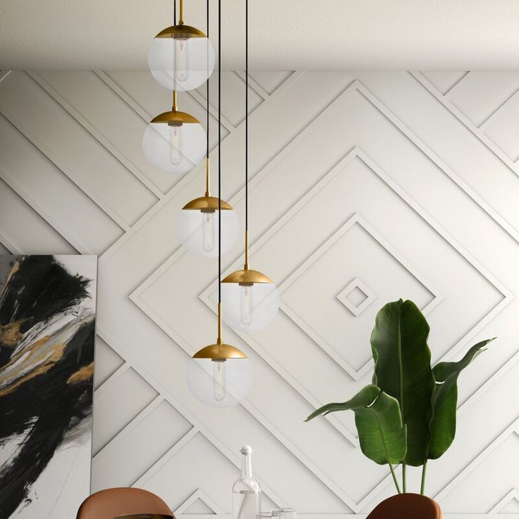 a dining room table with two chairs and three hanging lights