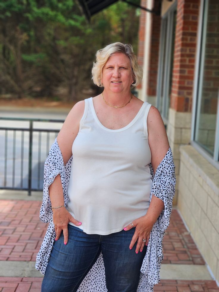 Back to the basics with this adorable Scoop Neck Ribbed Tank in White! Be sure to add it to your wardrobe to help beat the heat this summer. This beauty is paired with one of our top selling cardigans. Have no fear though, you can dress it both up and down or simply use it for layering. A versatile piece you can use all year long. ABOUT THIS ITEM: Made in China. Fabric is 60% Cotton / 35% Polyester / 5% Spandex. Machine wash in cold. Tumble dry on low. The Model is 5'9, and wearing a 1x. Spring Lightweight Relaxed Fit Tops, Versatile Lightweight Spring Tops, Lightweight Solid Tops For Summer, Lightweight Solid Color Summer Tops, Casual Lightweight Spring Tops, Lightweight White Top For Spring, Lightweight Tops For Summer Day Out, White Lightweight Top For Spring, Lightweight Summer Tops For Day Out