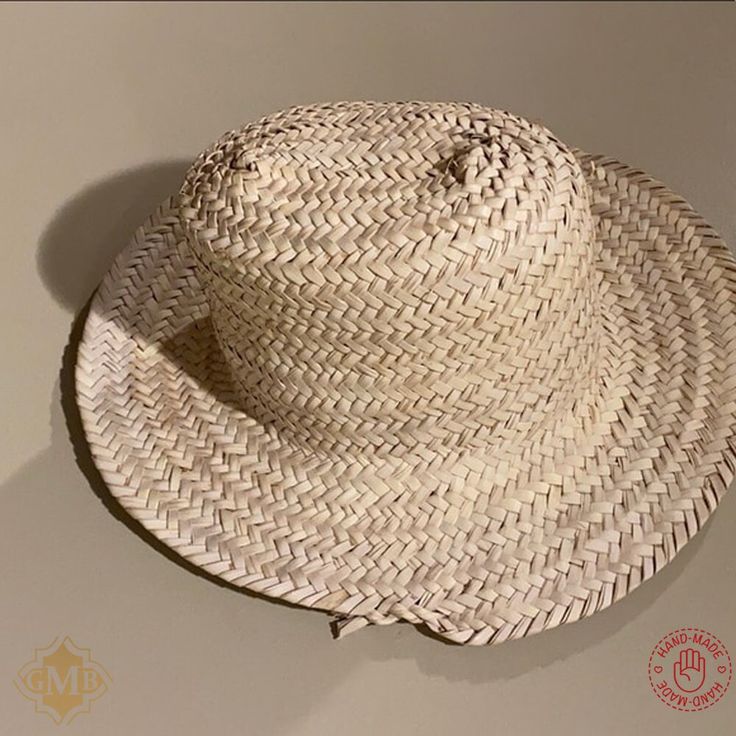 This Straw Hat sun are 100% handmade by artisans in Northern Morocco. and has been completely handmade. The dried palm leaf hat made from wild palm leavesare by free hand, with the straw Hat Natural palm. This Hand-Woven straw hats. Perfect for sunning your buns but keeping your pretty face shaded this summer! Features : Material : Harvested from the Doum palm Color : As Picture Size: Approx. 40 to 50 cm / 15.7 to 19.6 Inches Shap : Rounded Brand : Grand Moroccan Bazaar Condition : New Ethnic and traditional look Can be reshaped when wet. Ideal for the beach or working in the garden, a decoration on the wall. NOTE : Due to the nature of artisanship, a small variation in color, size, or design may occur. which make them even more beautiful and charming. Artisan Woven Straw Hat For Summer, Artisan Handwoven Summer Straw Hat, Bohemian Palm Leaf Boater Hat With Short Brim, Artisan Natural Colored Sun Hat For Vacation, Bohemian Short Brim Boater Hat, Artisan Natural Sun Hat For Vacation, Bohemian Brimmed Straw Hat Made Of Palm Leaf, Artisan Palm Leaf Sun Hat For Beach, Bohemian Brimmed Straw Hat From Palm Leaf