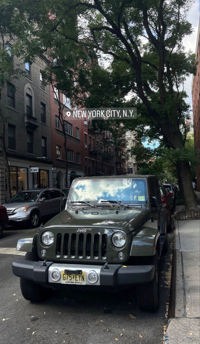 the jeep is parked on the side of the street