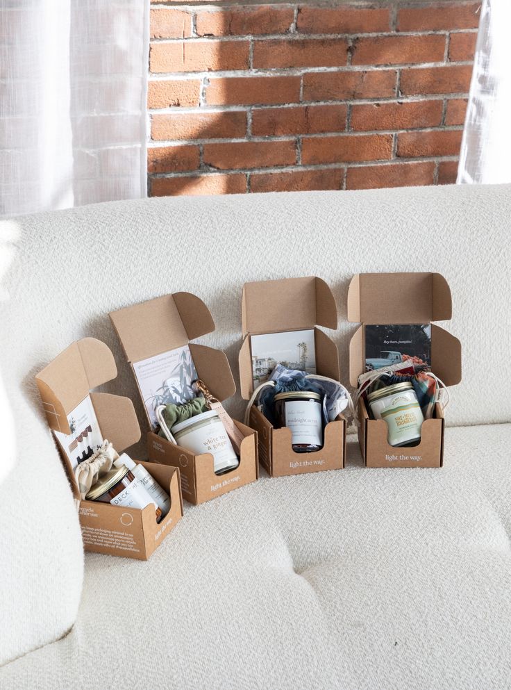 several open boxes sitting on top of a white couch