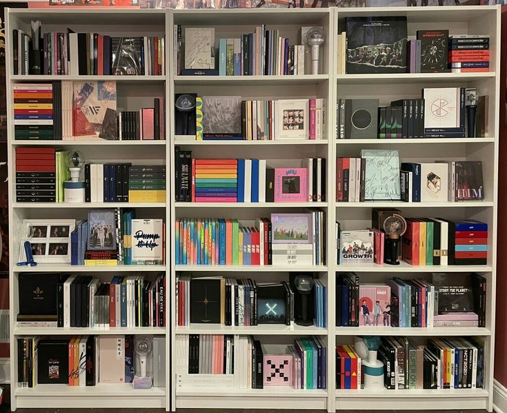 a bookshelf filled with lots of different types of books on top of white shelves