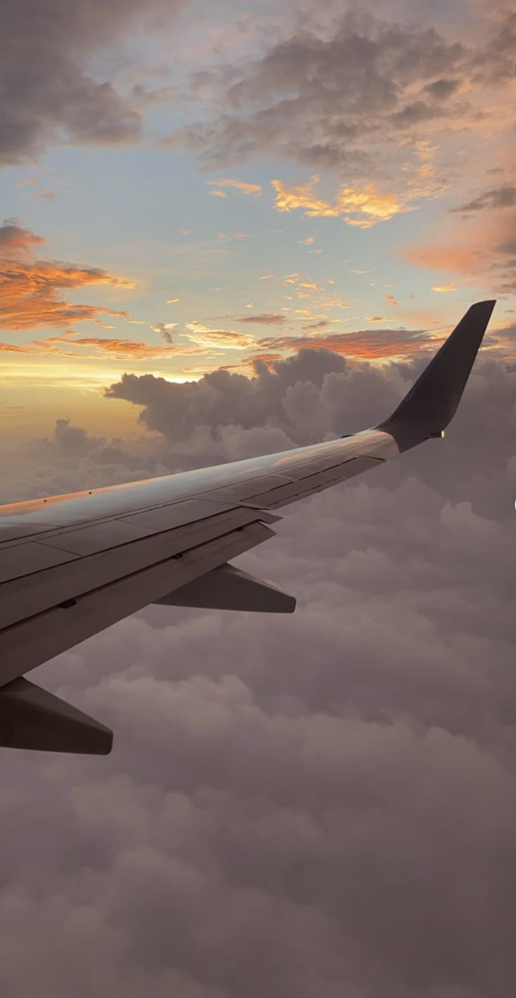 the wing of an airplane as it flies through the clouds