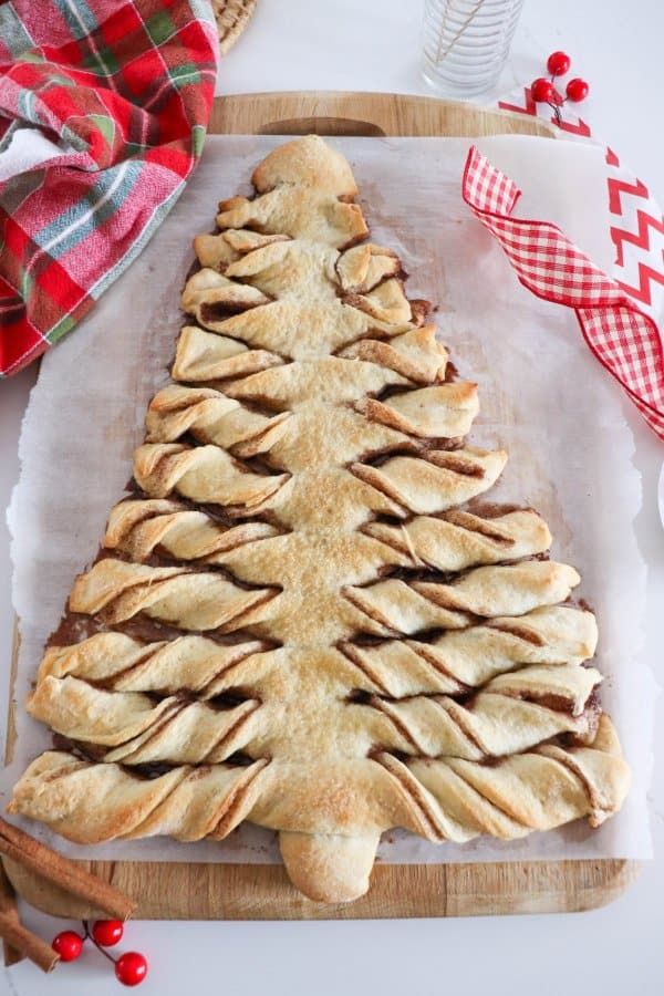 a christmas tree shaped pastry sitting on top of a cutting board