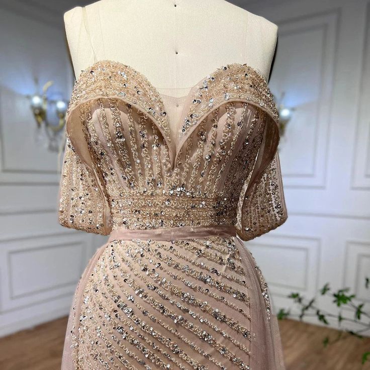 a dress that is on a mannequin with sequins and beads around it