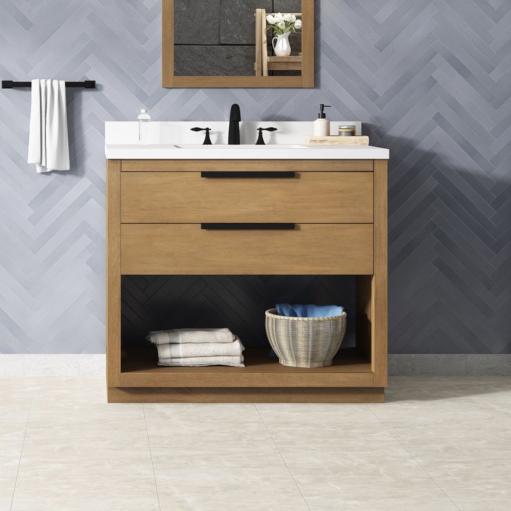 a bathroom with a sink, mirror and towels on the shelf in front of it