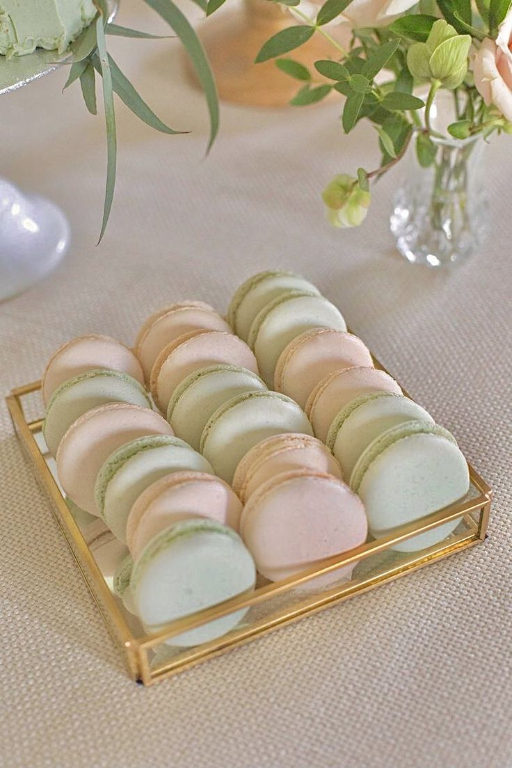 macaroons are arranged on a gold tray