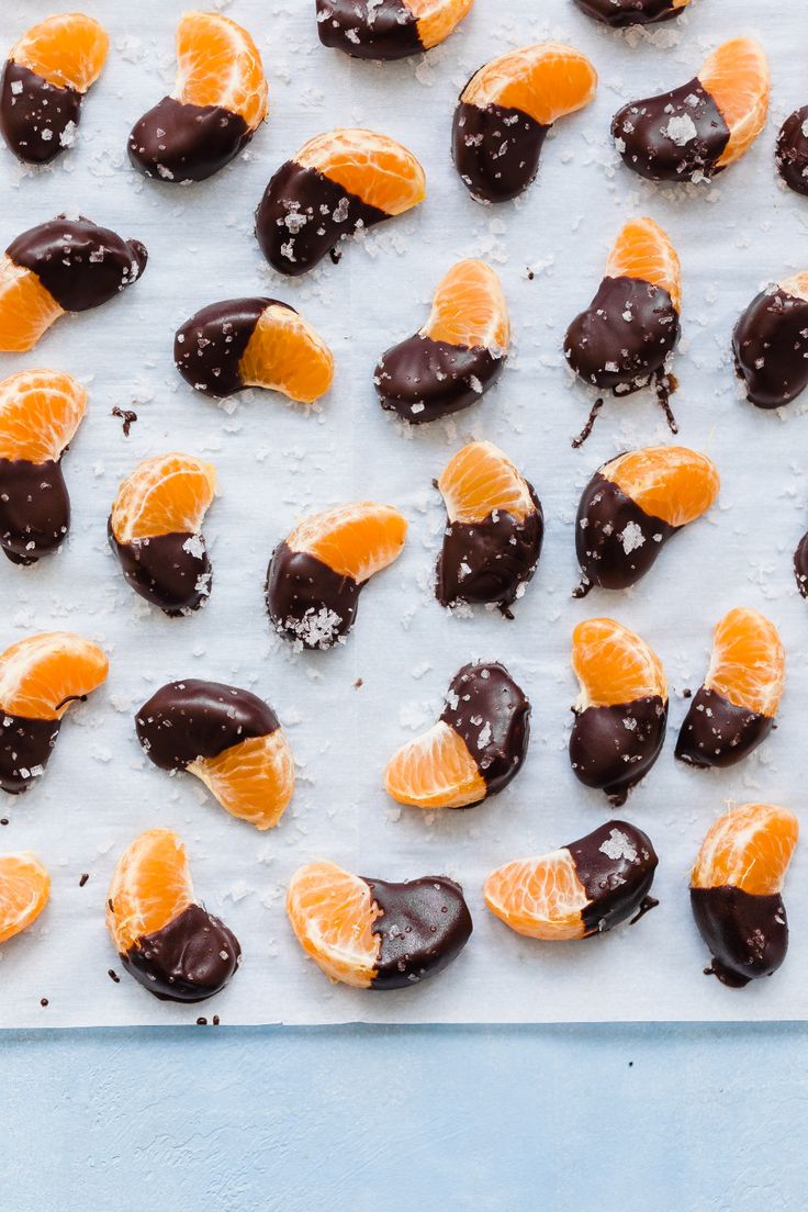 chocolate covered orange slices and candies on a baking sheet