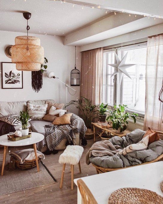 a living room filled with furniture and lots of plants on top of it's windowsill