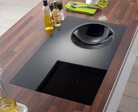 a kitchen counter with an oven and cooking utensils on it