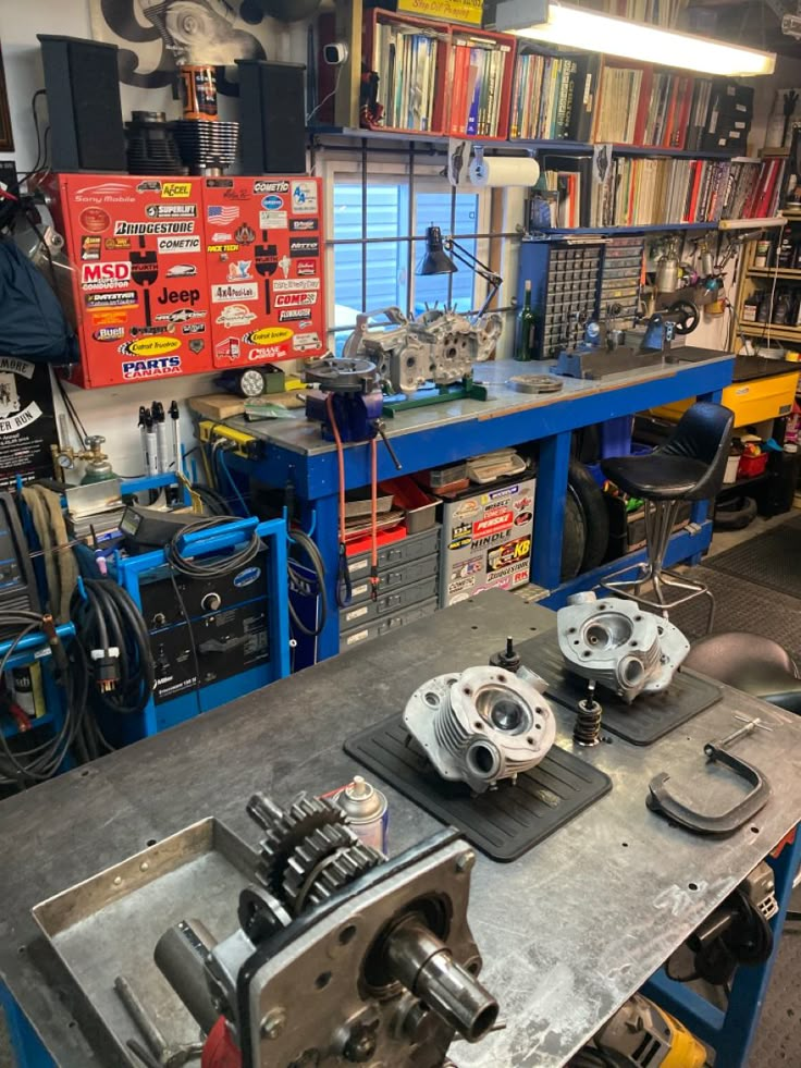 the shop is filled with many different types of tools and equipment, including an engine