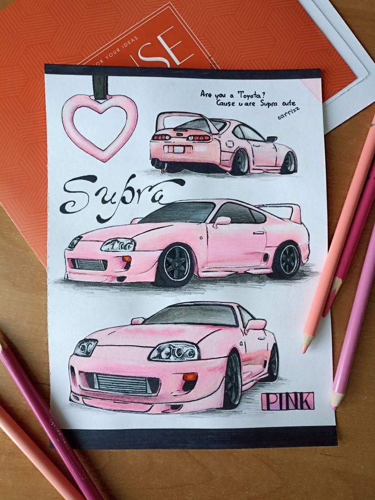 two pink sports cars on a card with pencils next to it