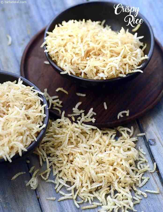 two black bowls filled with shredded cheese on top of a wooden table next to another bowl full of shredded cheese