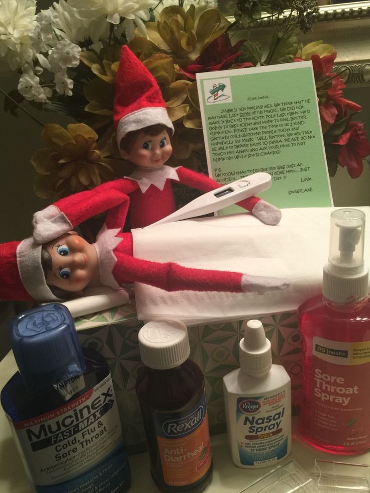 an elf is sitting on top of a table with bottles and toothbrushes in front of him