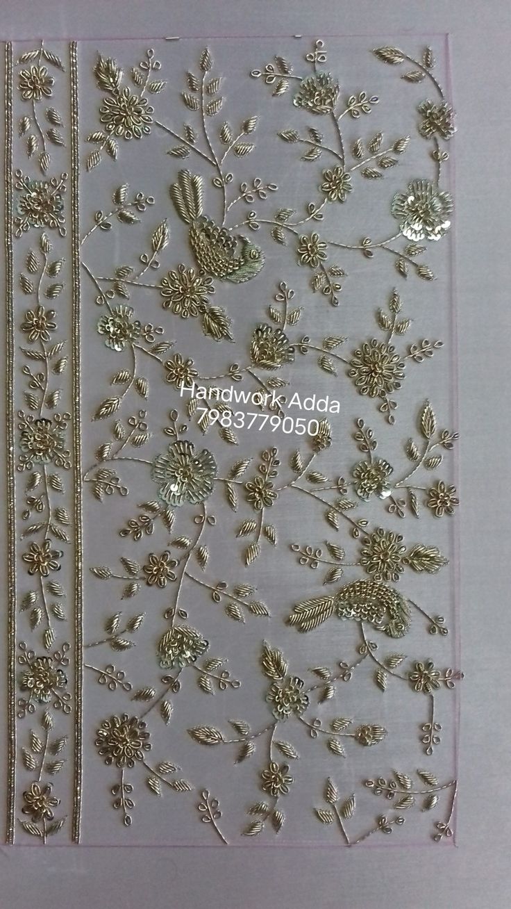 the back side of a card with gold flowers and leaves on it