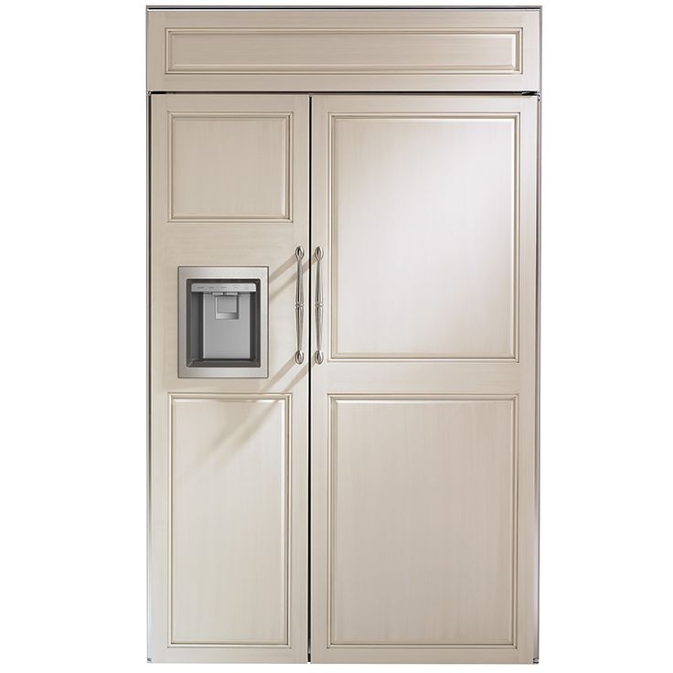 a white refrigerator freezer sitting inside of a wooden cabinet next to a metal door