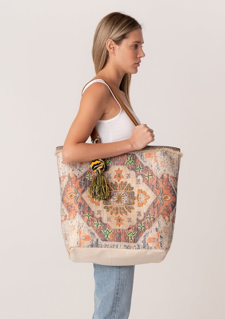 A classic bohemian tapestry tote bag with embroidered detail throughout. Tapestry tote bag Embroidered detail Suede leather double strap handles Magnetic closure Inner zip pocket Tassel accent Bohemian tote bag Inspired by some of our favorite vintage bags, our large-sized tote features a beautiful tapestry design and embroidered details throughout. Featuring double suede straps for easy carrying. Dimensions: H 18" x W 20" x D 6 5/8"Style: DR-904-1 Tote Bag Embroidery, Beautiful Tapestry, Bag Embroidery, Boho Tote Bag, Boho Tote, Boho Tapestry, Bohemian Tapestry, Travel Tote Bag, Embroidered Details