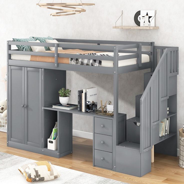 a loft bed with desk underneath it and stairs leading up to the top bunkbed