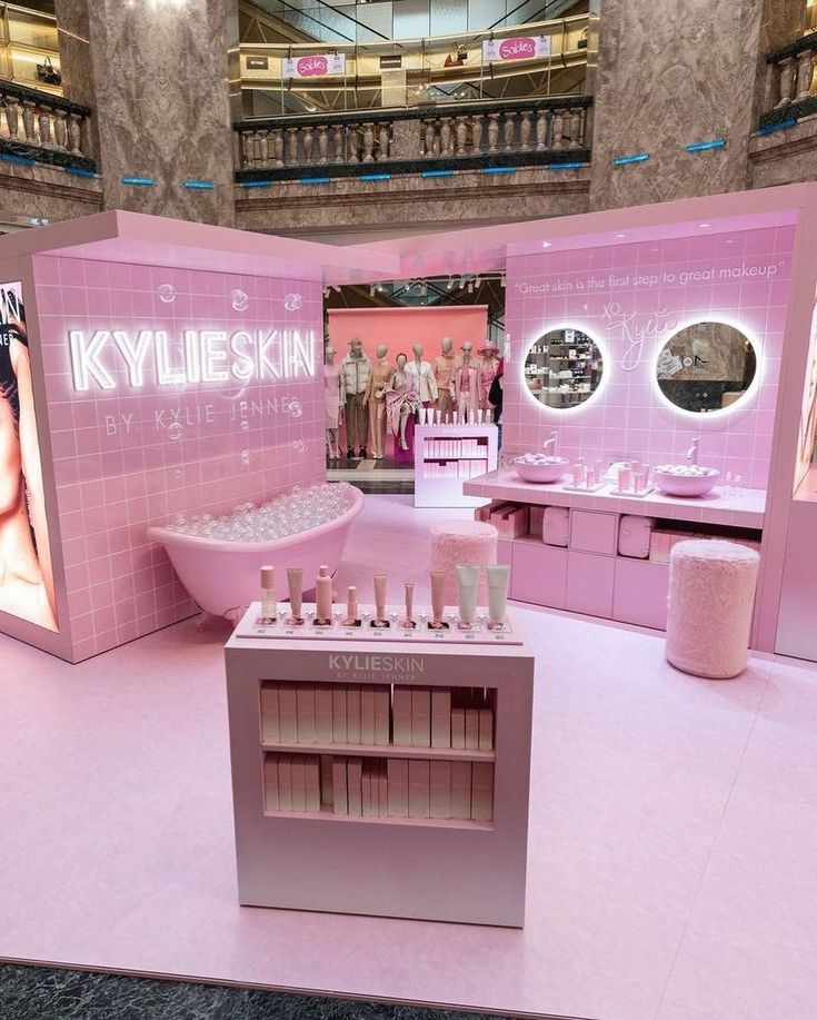 a display in a store with pink walls and flooring