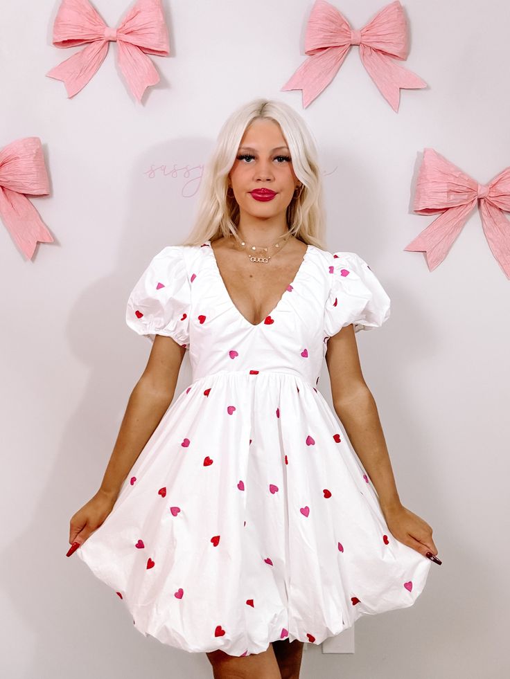 Turn heads and steal hearts in the Mark My Love dress from Sassy Shortcake. This playful white dress boasts puff sleeves and skirt. Red and pink embroidered hearts are placed throughout on both the front and back of this pretty. She features a v-neck and hidden back zipper. Lined. fits true to size, model wearing a size small also available in red. Cute Pink Dress For Valentine's Day, White Sweet Style Puff Sleeve Dress, Cute White Dress With Puff Sleeves, White Flirty Dress With Puff Sleeves, Cute White V-neck Dress, White V-neck Cute Dress, White Puff Sleeve Flirty Dress, Cute Heart Print Dresses For Spring, Cute White Mini Dress With Sweetheart Neckline